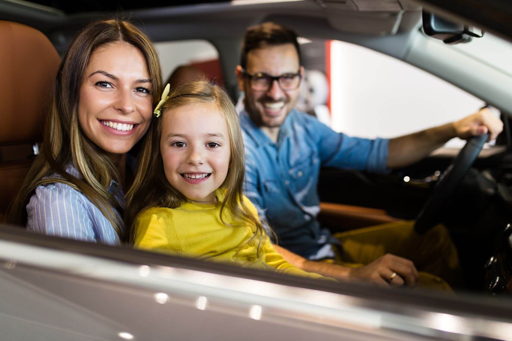 Family smiling in car
